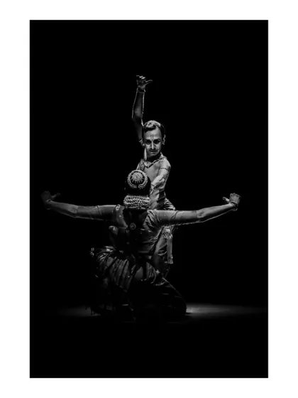 A dramatic, high-contrast shot from "Tyāgarāja Hṛt Sādana." The use of lighting is crucial in our productions to create mood and highlight key moments in the choreography.