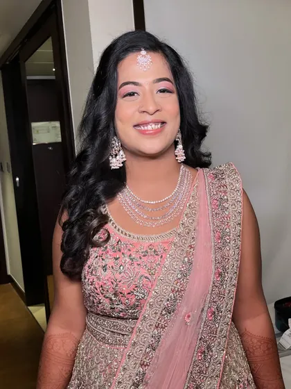 A final look at Ritu's engagement makeup. The soft curls and glowing skin create a timeless and elegant style that is perfect for any pre-wedding celebration.