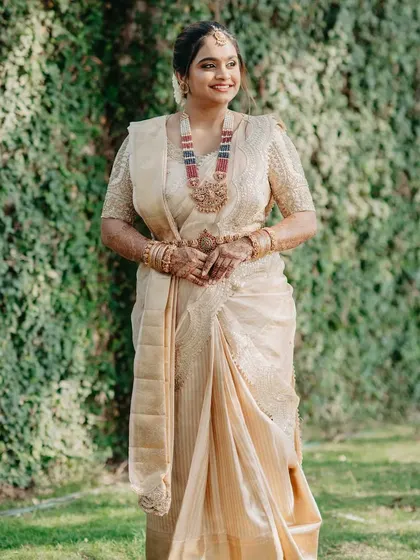 Our gorgeous client shines in an ivory-gold saree paired with a custom Ganavi Couture blouse. This look was her mother's dream come true, a beautiful blend of tradition, emotion, and handcrafted love.
