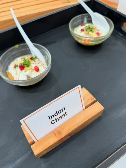 A single serving of our delicious Indori Chaat, prepared at a live counter for a corporate meet. It's a perfect mix of textures and flavors, served in a convenient bowl for guests to enjoy while mingling.