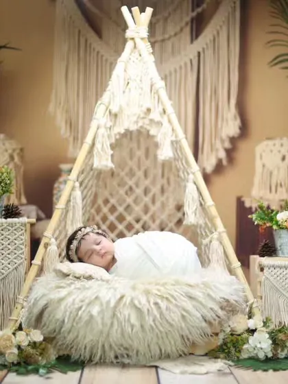 This dreamy boho-chic setup features a miniature macrame teepee, soft furs, and natural textures. It’s one of our most requested styles for parents looking for an earthy and artistic newborn session.