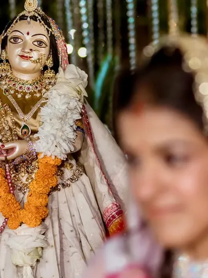 A unique and personal portrait for a bride who loves Krishna. I used a shallow depth of field to focus on the deity's idol, with the bride softly blurred in the background.
