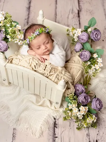 For a touch of elegance, I design elaborate floral setups like this one. Nestled in a tiny bed surrounded by fresh flowers, your baby becomes the centerpiece of a beautiful, artistic portrait.