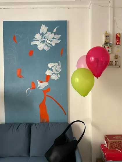 A quiet corner of my studio, where a finished painting lives for a while before going to its new home. The balloons add a touch of accidental celebration.