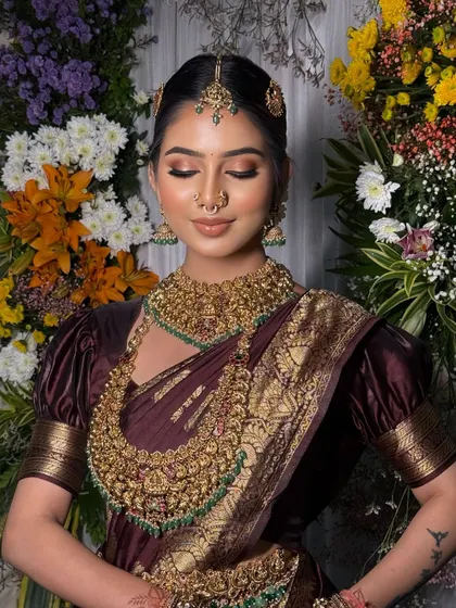 A close-up of the bride's serene expression, with the rich saree and jewellery completing the look.