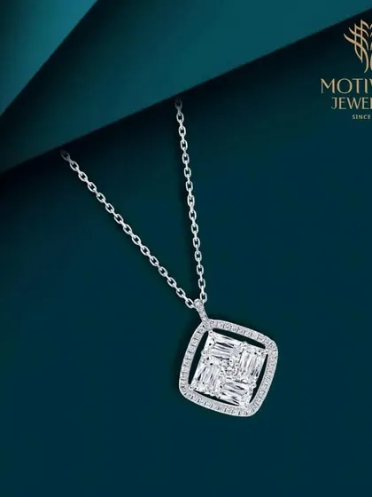 A modern pendant with an illusion setting of baguette diamonds, creating the look of a much larger single stone. It is a contemporary piece that is both smart and stylish.