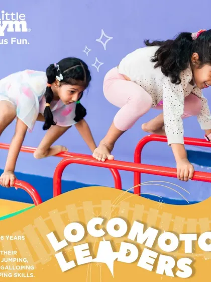 Two girls practice their form on the parallel bars. This activity helps our 'Locomotor Leaders' refine their coordination and build strength while learning to work alongside their peers.