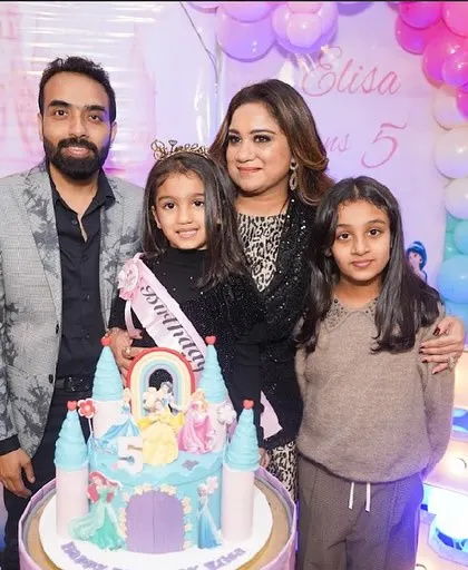 A beautiful family portrait during a princess-themed cake cutting ceremony.