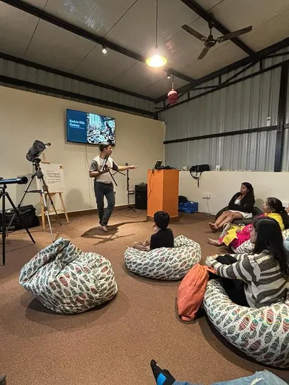An attendee learns about different types of telescopes during our 'Telescope Exploration' workshop. I love hosting events that spark curiosity and learning.