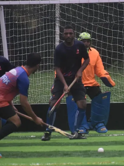 An intense moment in front of the goal as our attacker tries to get a shot past the opposing team's defense and goalkeeper.