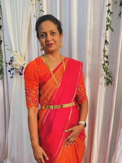 Our dearest Shalini radiates elegance in this vibrant orange saree. She shines bright with the warmth, energy, and joy of the Navratri festival.