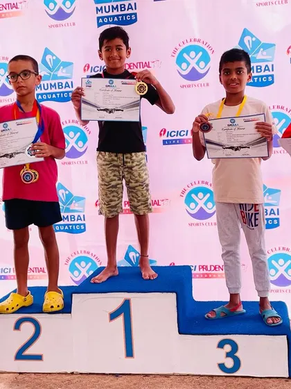 Even when not at 100%, a champion's spirit shines through. Bryce stands on the podium after winning third place in the 50m breaststroke at the GMAAA swim meet, a result he achieved despite battling a high fever. This demonstrates the mental toughness we instill in our athletes.