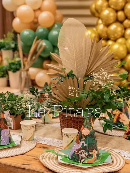A close-up of the kids' table setting, showing the detailed party hats and dried floral arrangements that add a rustic touch.