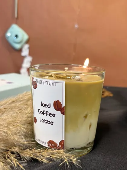 My classic Iced Coffee Latte candle, lit and glowing. The rich brown color and coffee bean details make it a must-have for any coffee lover.