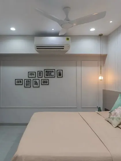 Another angle of the bedroom, focusing on the simple yet elegant TV unit and the beautiful wall molding that adds architectural interest to the space.