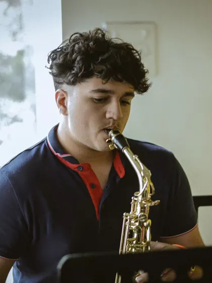 A student playing the saxophone at our recital. We offer training in a wide variety of instruments, including brass and woodwinds.
