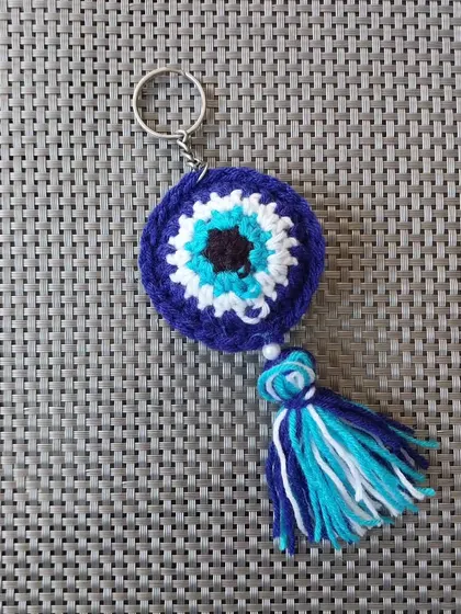 My signature evil eye keychain, handmade with love. This design is a customer favorite for return gifts and corporate freebies, featuring a crochet evil eye, a colorful tassel, and a small pearl for that extra touch.