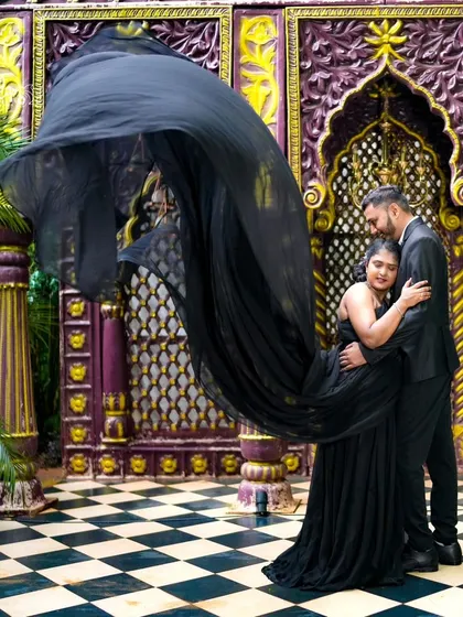 I love creating dramatic and stylish pre-wedding photos. This shot features a beautiful flowing black gown against a stunning architectural backdrop, showing the kind of high-fashion look we can achieve together.