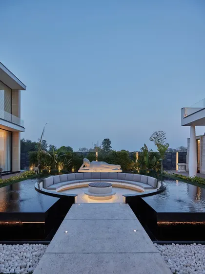 Serenity is a cornerstone of our design philosophy. This sunken circular seating area, built around a fire pit and a tranquil water body, is watched over by a reclining Buddha statue. It is a space meticulously crafted for balance, meditation, and quiet contemplation, offering a peaceful retreat from the everyday.