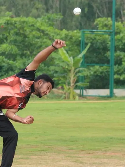 A bowler releases the ball, captured at the moment of delivery.