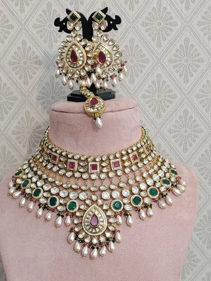 A multi-colored Kundan choker set that can be paired with many different outfits. The combination of red, green, and white stones makes it very versatile.