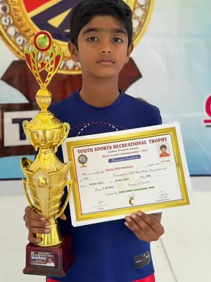 Shaurya proudly holding his winner's trophy after winning the U12 Andhra Pradesh state tournament.