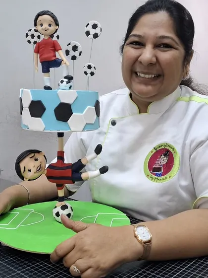 Here I am with the football-themed anti-gravity cake from my masterclass. It’s always a proud moment to see a complex idea come to life.