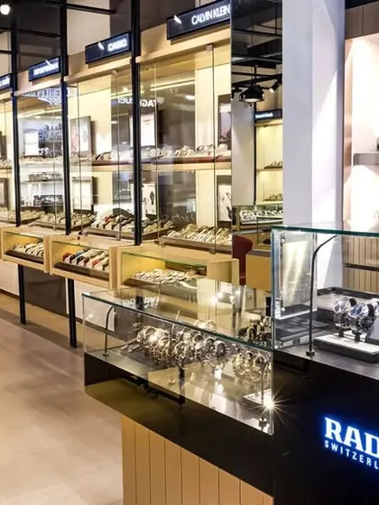 A side view of the store interior, showing the high-end Rado display section and the general flow of the retail space.