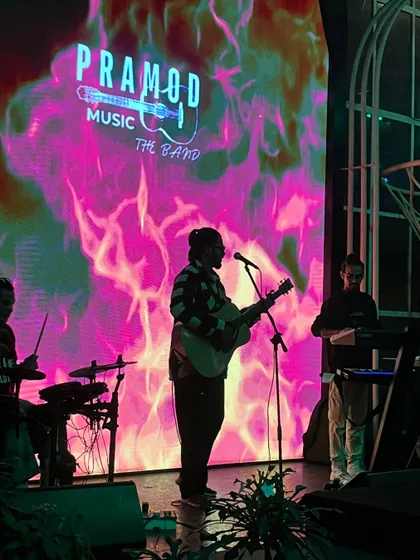 Here is my full band on stage, silhouetted against a dynamic LED backdrop. We use professional lighting and visuals to create a powerful stage presence that elevates the atmosphere of any large pub or event space.