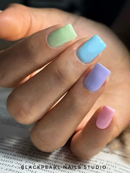 A fun and uplifting "candy crush" manicure featuring a different pastel shade on each finger. This look is perfect for lifting your mood and embracing a playful, colorful vibe.