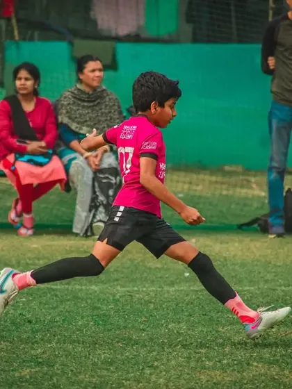A powerful shot from a player in a pink jersey.