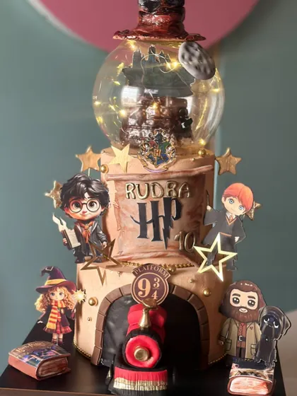 "I solemnly swear that this cake is up to no good." A magical Harry Potter cake complete with the Sorting Hat, Platform 9¾, and a glowing snow globe, perfect for any wizard or witch.
