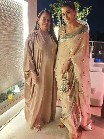 With my mom, wearing a beige sequin saree by Sabyasachi. It's a glamorous yet elegant option for a reception or cocktail party.
