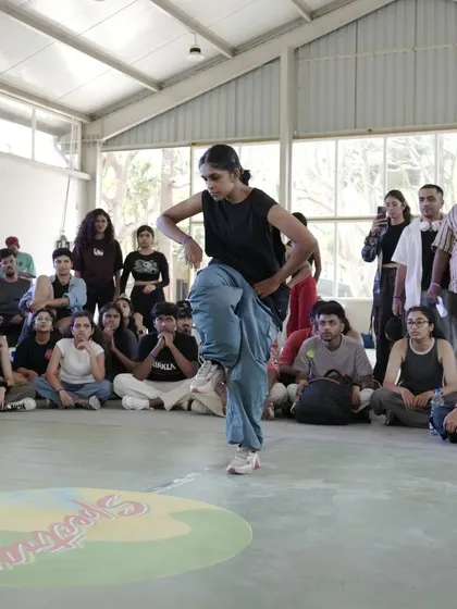 A dancer in the zone during the battles at Spectra, with the crowd watching intently.