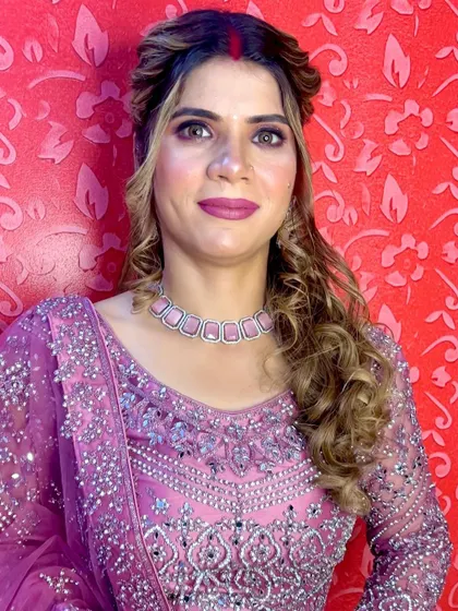 A close-up of the beautiful makeup and jewelry paired with the magenta lehenga. The pink tones in the jewelry complement the outfit perfectly.