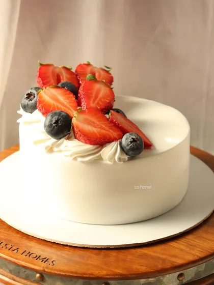 A close-up of the fresh strawberries and blueberries on this simple and delicious cake.