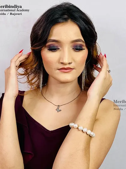 This image showcases the texture and highlights in the hair, styled with gentle waves for a modern party look.
