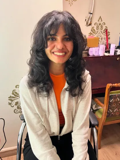 A shag haircut that makes the most of Amrita’s thick natural hair texture.