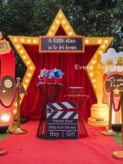 Announcing the arrival of a little star with a 'Lights! Camera! Baby!' themed baby shower. This fun, glamorous setup includes a red carpet entrance, a marquee star, and movie-themed props, making the parents-to-be feel like true celebrities.
