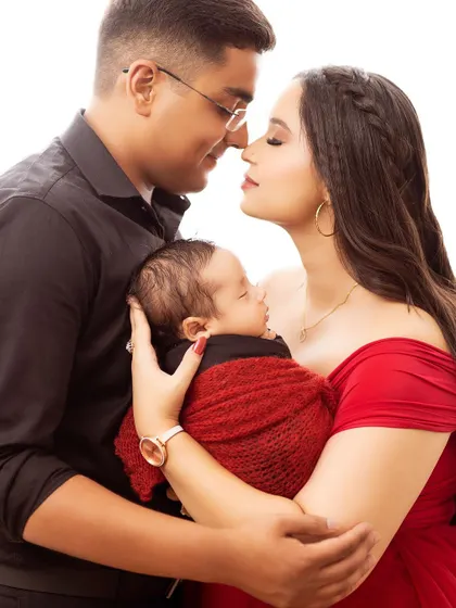 An intimate close-up of new parents and their baby. This nose-to-nose pose is a beautiful way to show the connection and love in a new family.