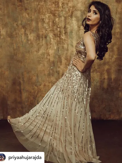 A dynamic pose from the fashion shoot. The bold lip and dramatic hair create a high-fashion, memorable image.