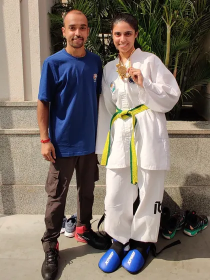 A proud moment with a student after her victory. The journey involves sweat and pain, but it always ends in victory and smiles.