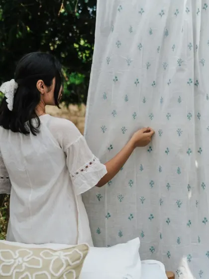 A closer look at the delicate buti print on our sheer cotton curtains. These small, repeating motifs add a touch of traditional charm while keeping the overall feel light and modern.