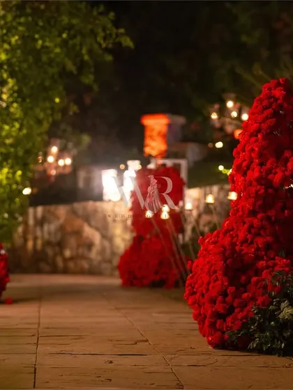The entrance pathway, flanked by abstract red floral sculptures and lit by candelabras. This was not just a path to be walked; it was an experience to be felt.
