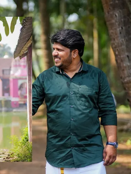 A candid shot of the groom during the pre-wedding shoot, capturing his relaxed smile against a natural, rustic backdrop.