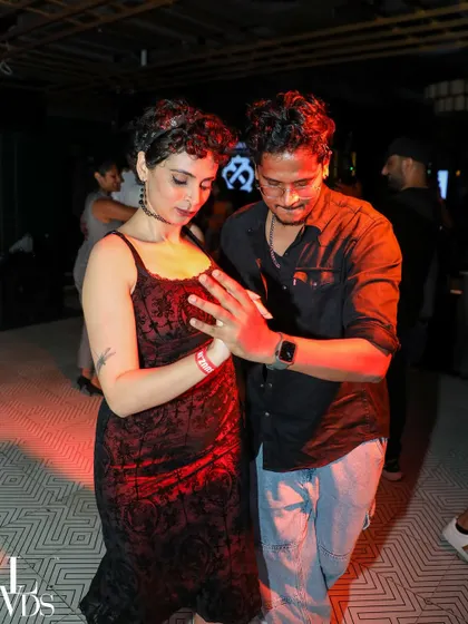 A focused couple in a close hold, practicing their moves. The studio is the perfect place for dedicated practice.