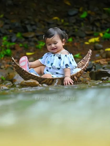 A candid moment of the baby playing with her shoe in the boat, full of innocent charm.