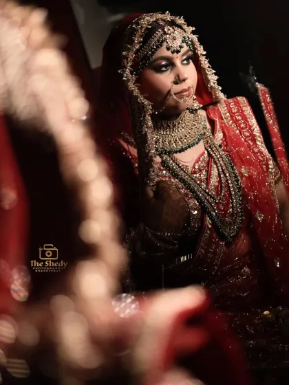 A creative bridal portrait using a reflection. This artistic shot provides a unique perspective and highlights the bride's elegance.