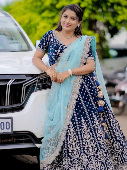 A confident pose from a happy client. The custom fit of her blue lehenga ensures she looks and feels her best.