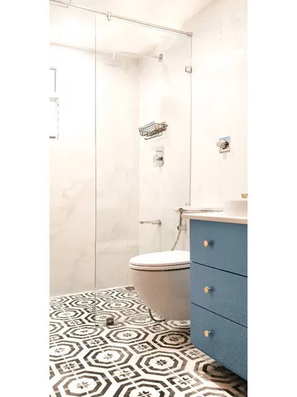 A detail shot of the guest bathroom remodel, showing the custom blue vanity. Adding a pop of color with cabinetry is one of my favorite ways to bring joy and personality into a bathroom design.